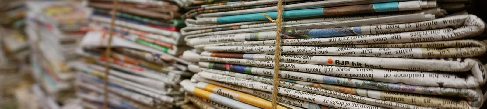Photo of bundles of newspaper.