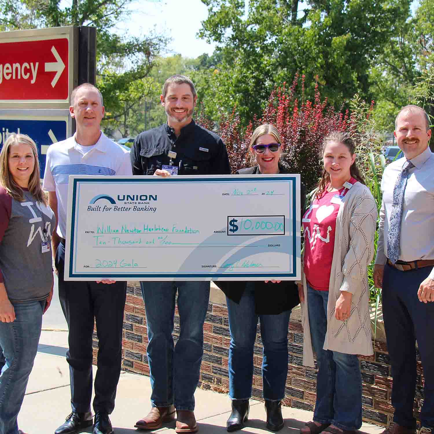 Photo of members of Union State Bank presenting an oversized check for $10,000 to William Newton Healthcare Foundation staff.