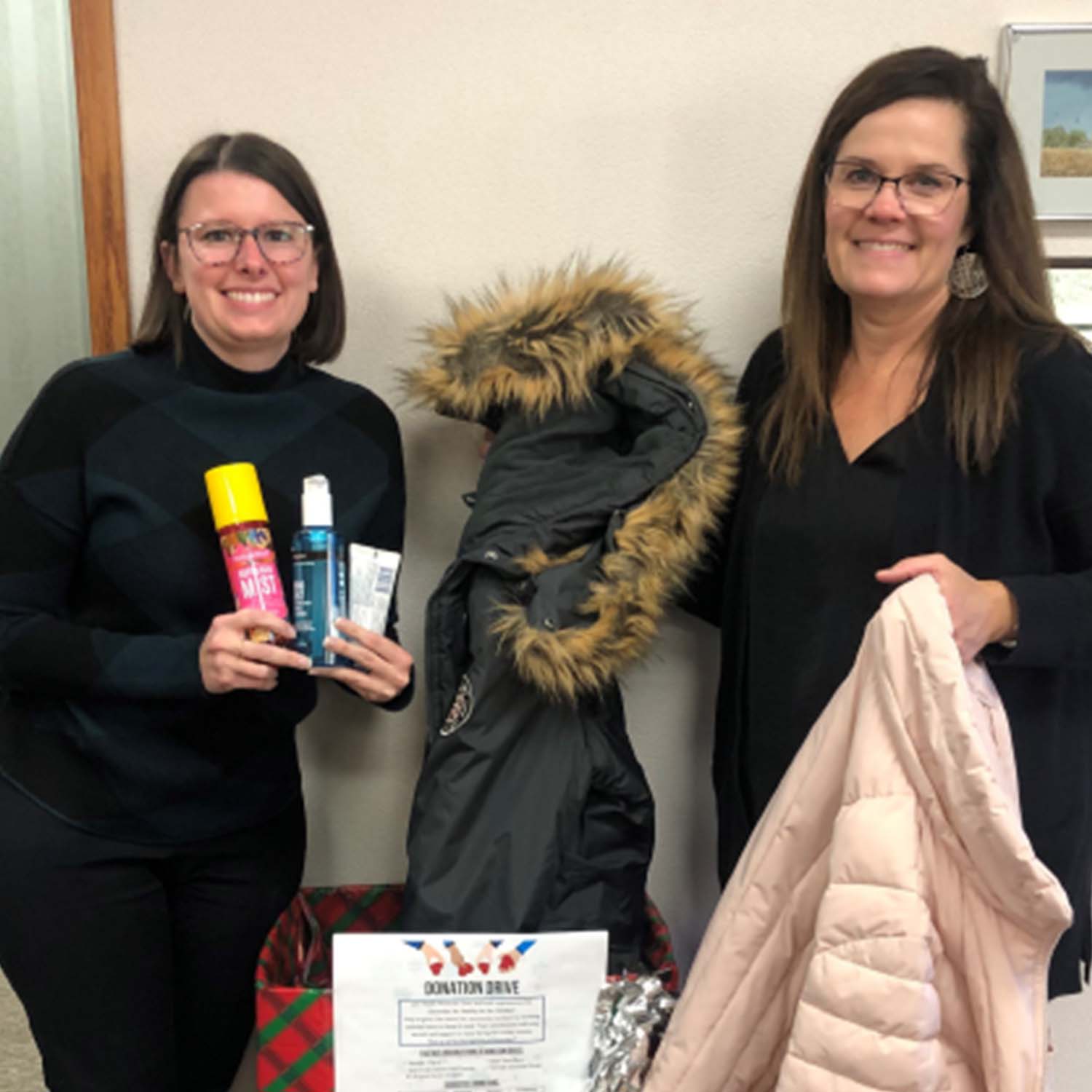 Photo of Union State Bank staff displaying items donated for the holidays.