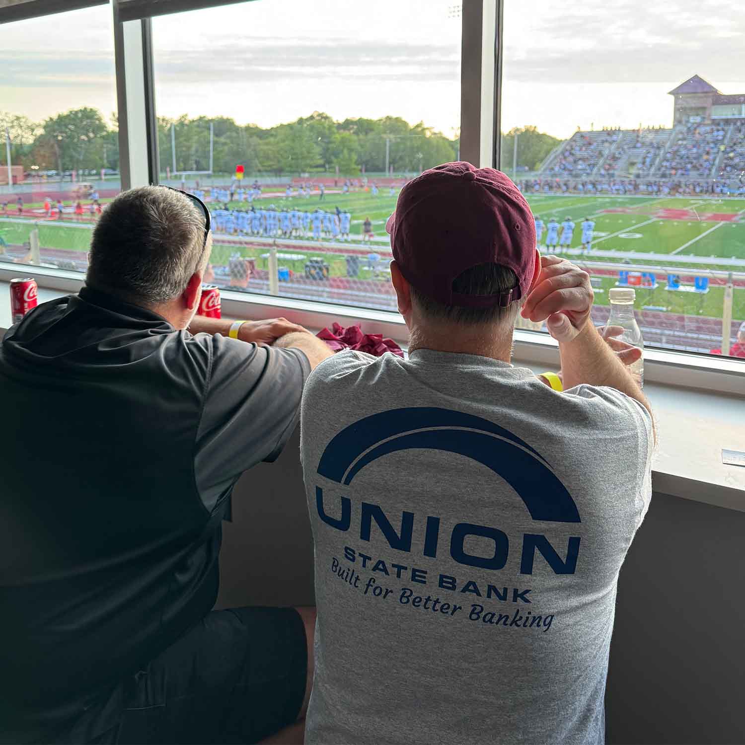 Photo of Bryan White, Union State Bank's Market President for Newton, KS watching a Bethel College football game.