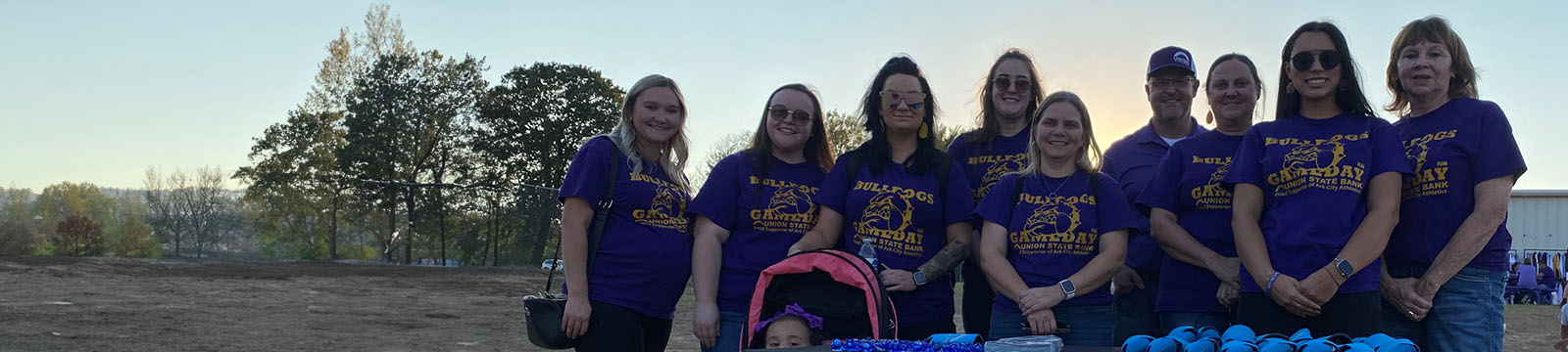 Photo of Union State Bank staff wearing their game day shirts at the Arkansas City High School football game.